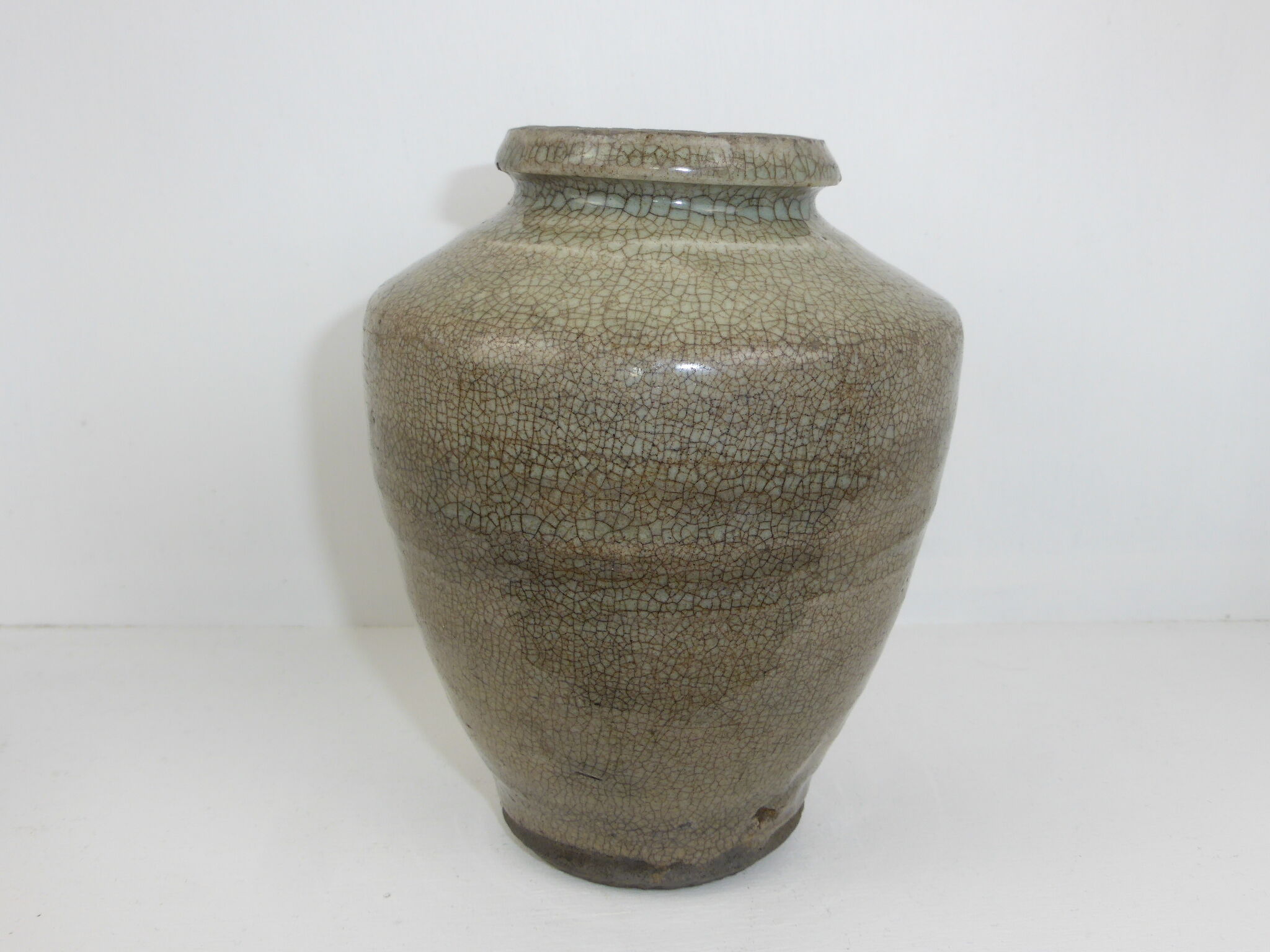 Ancient vase in khaki grey-green cracked sandstone