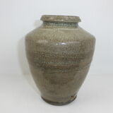 Ancient vase in khaki grey-green cracked sandstone