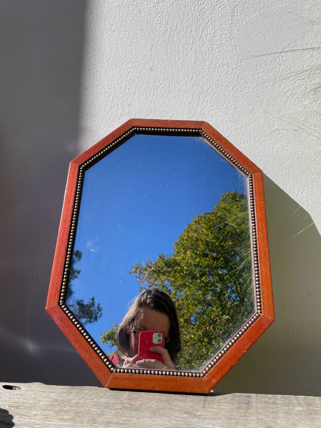 Octagonal beaded wooden mirror