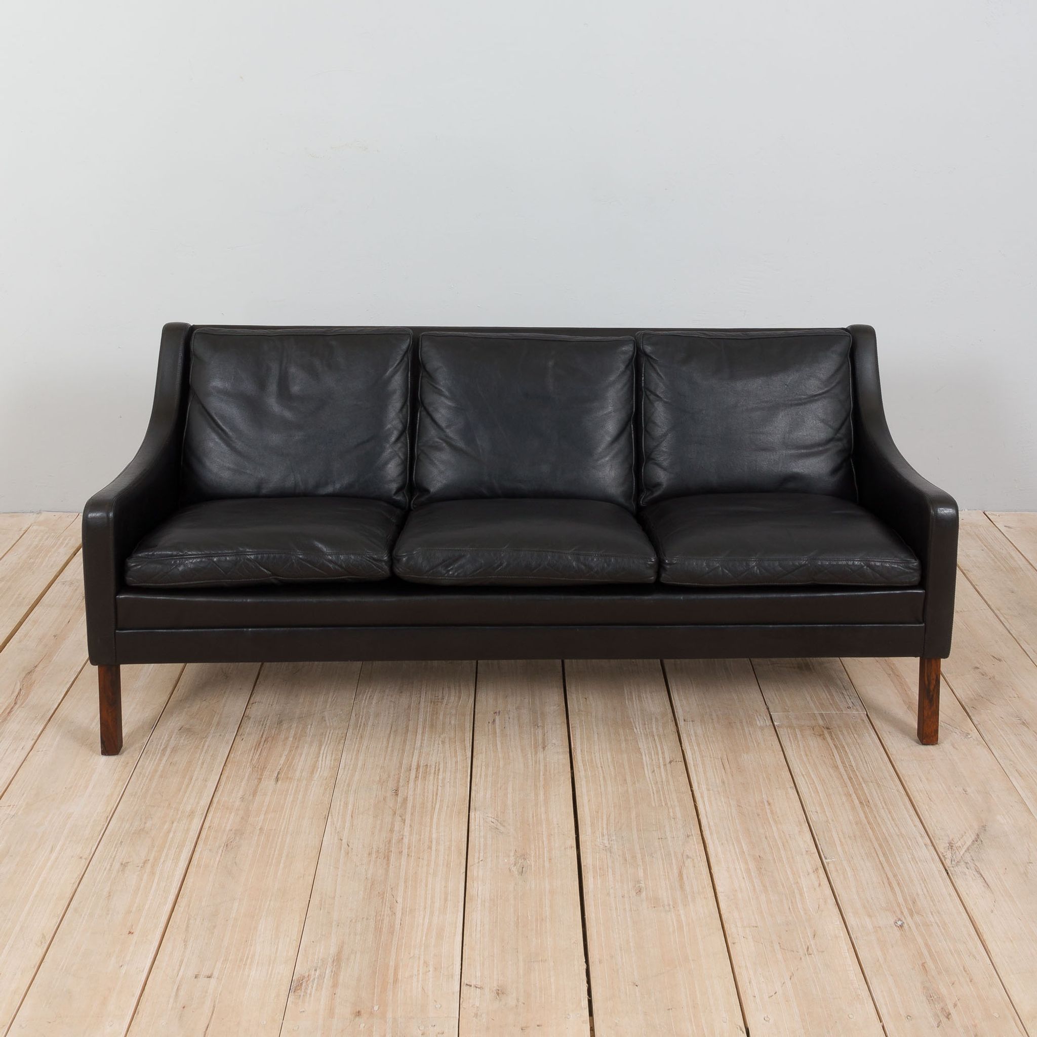 Danish black leather and rosewood sofa