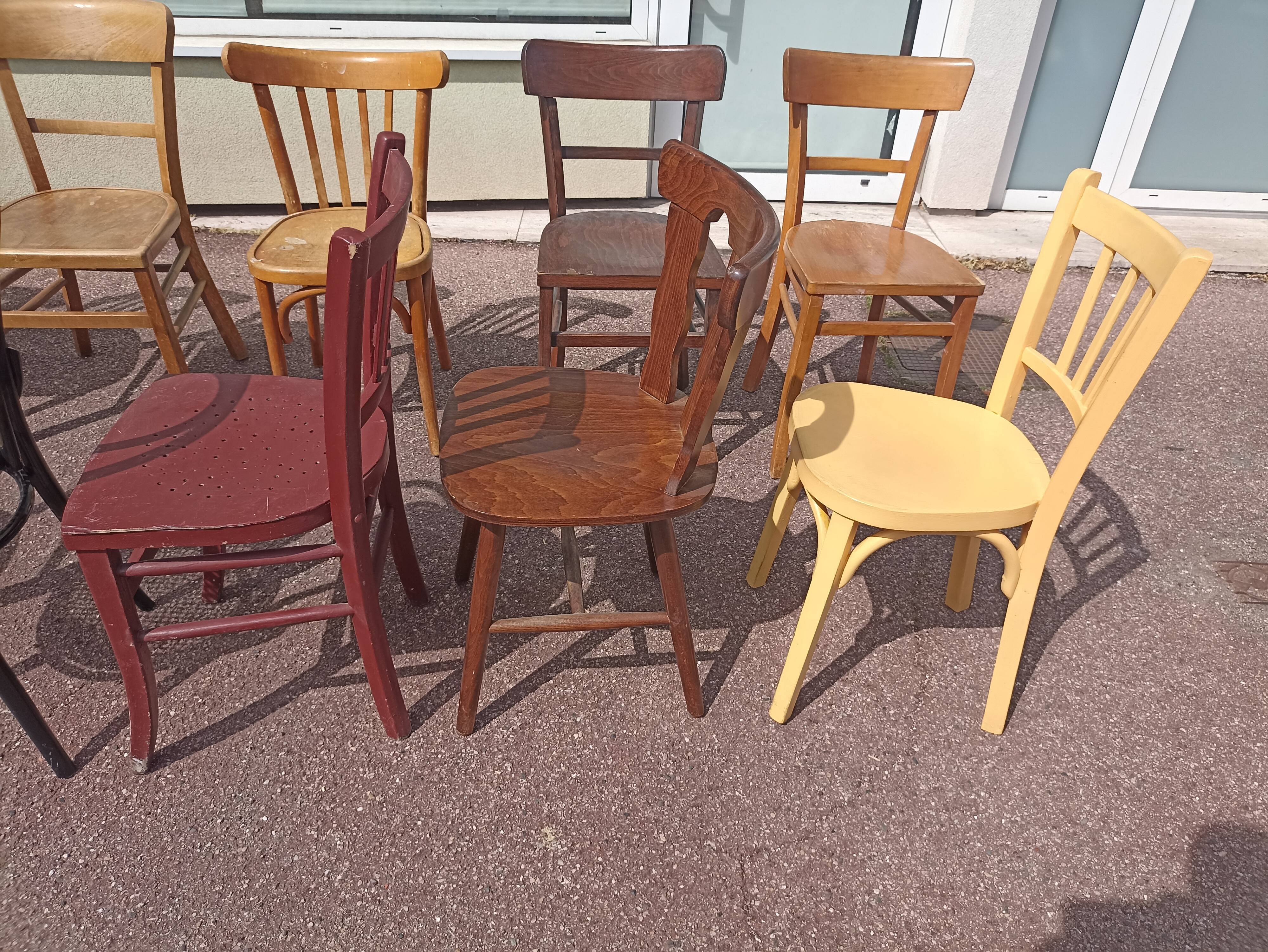 Set of 12 mismatched wooden bistro chairs