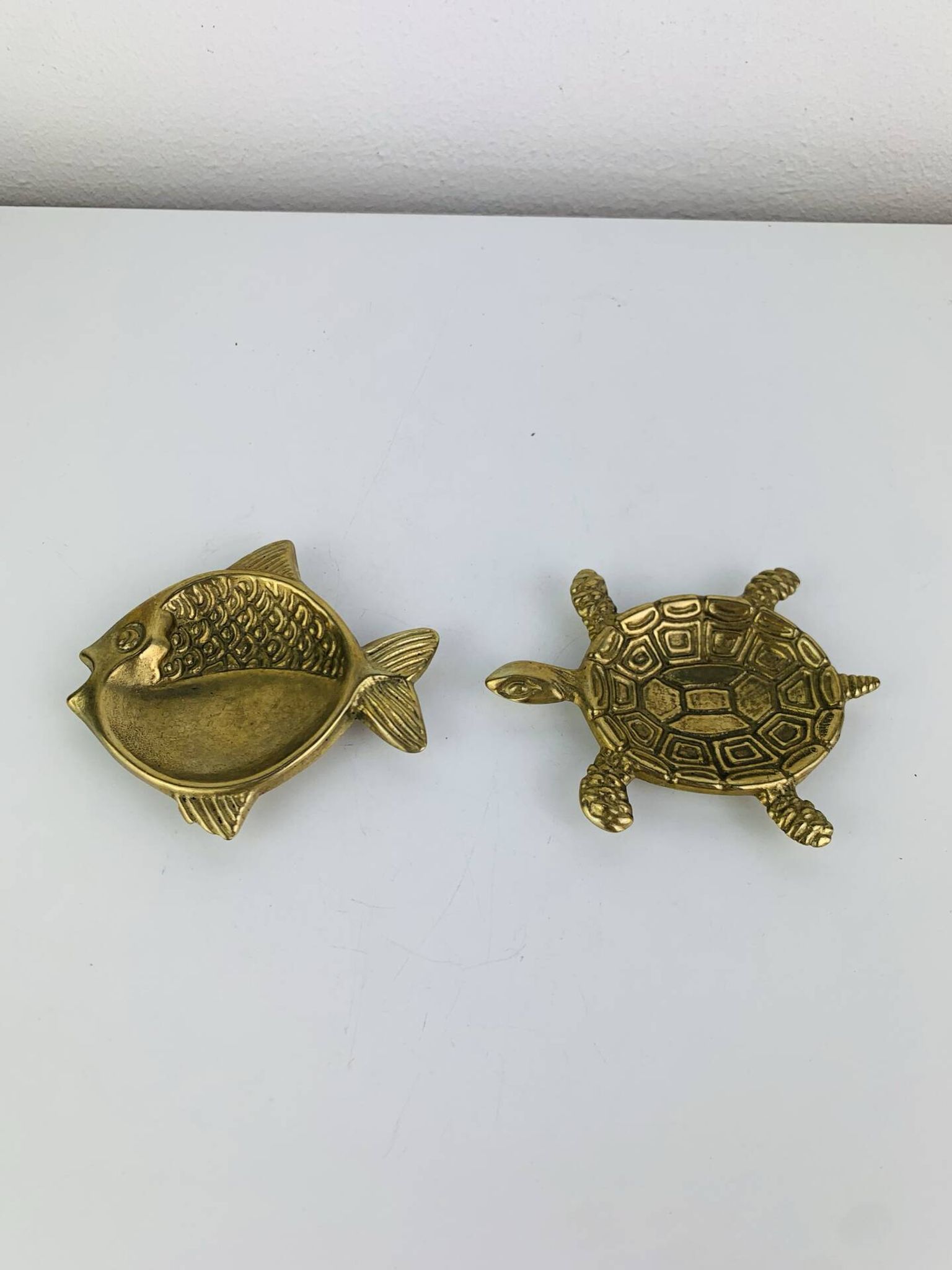 Pair of animal trinket trays in brass, fish and turtle.