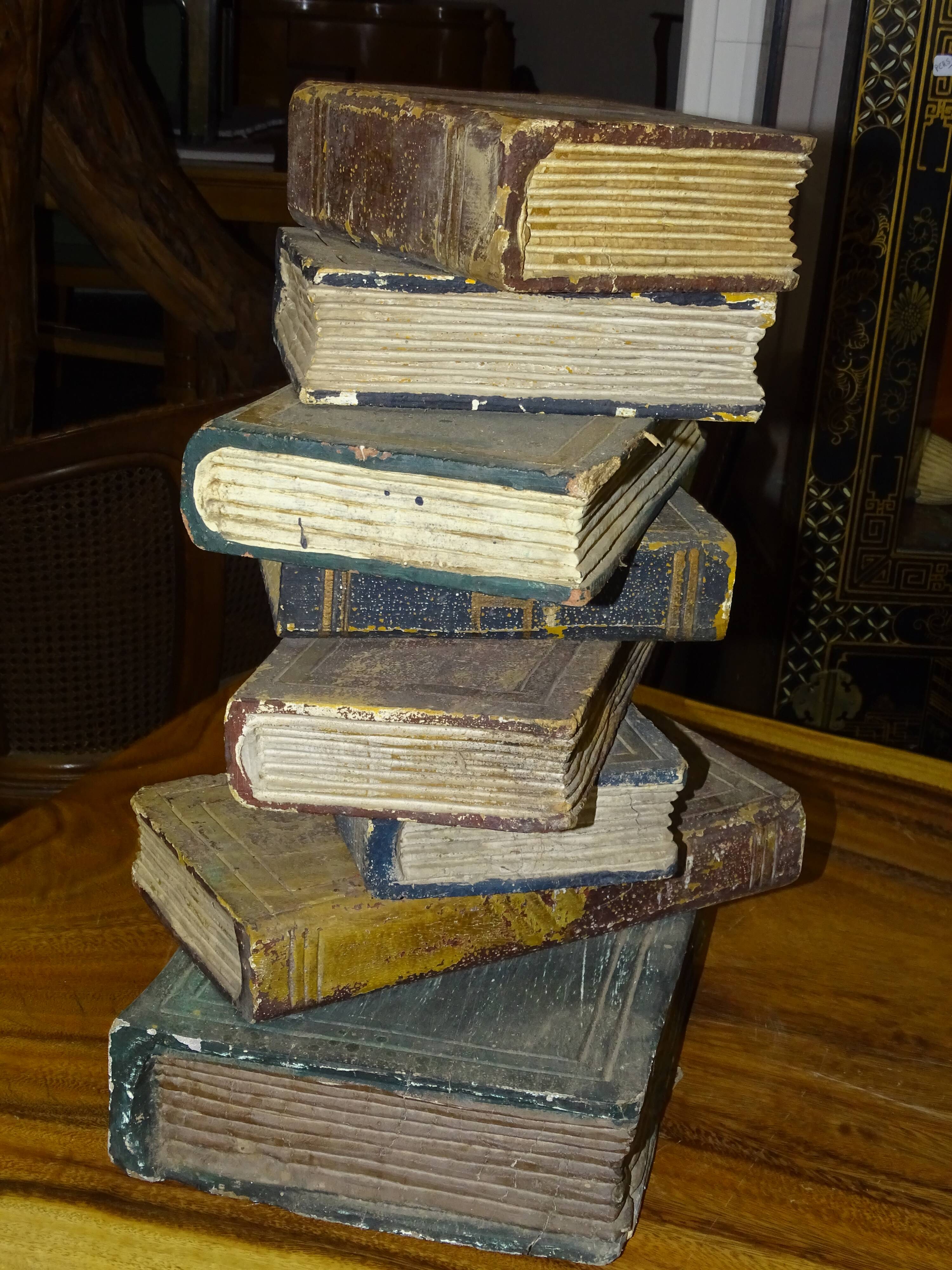 side table, end of sofa stack of wooden books, old, beautiful patina