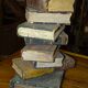 side table, end of sofa stack of wooden books, old, beautiful patina