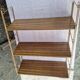 Wall shelf in metal with slanted shelves