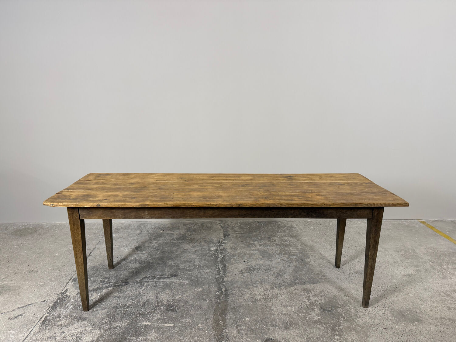 Old farmhouse table with tapered legs, late 19th to early 20th century.