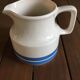 Porcelain pitcher stamped Oxford Ireland. Wide blue stripes on a white background