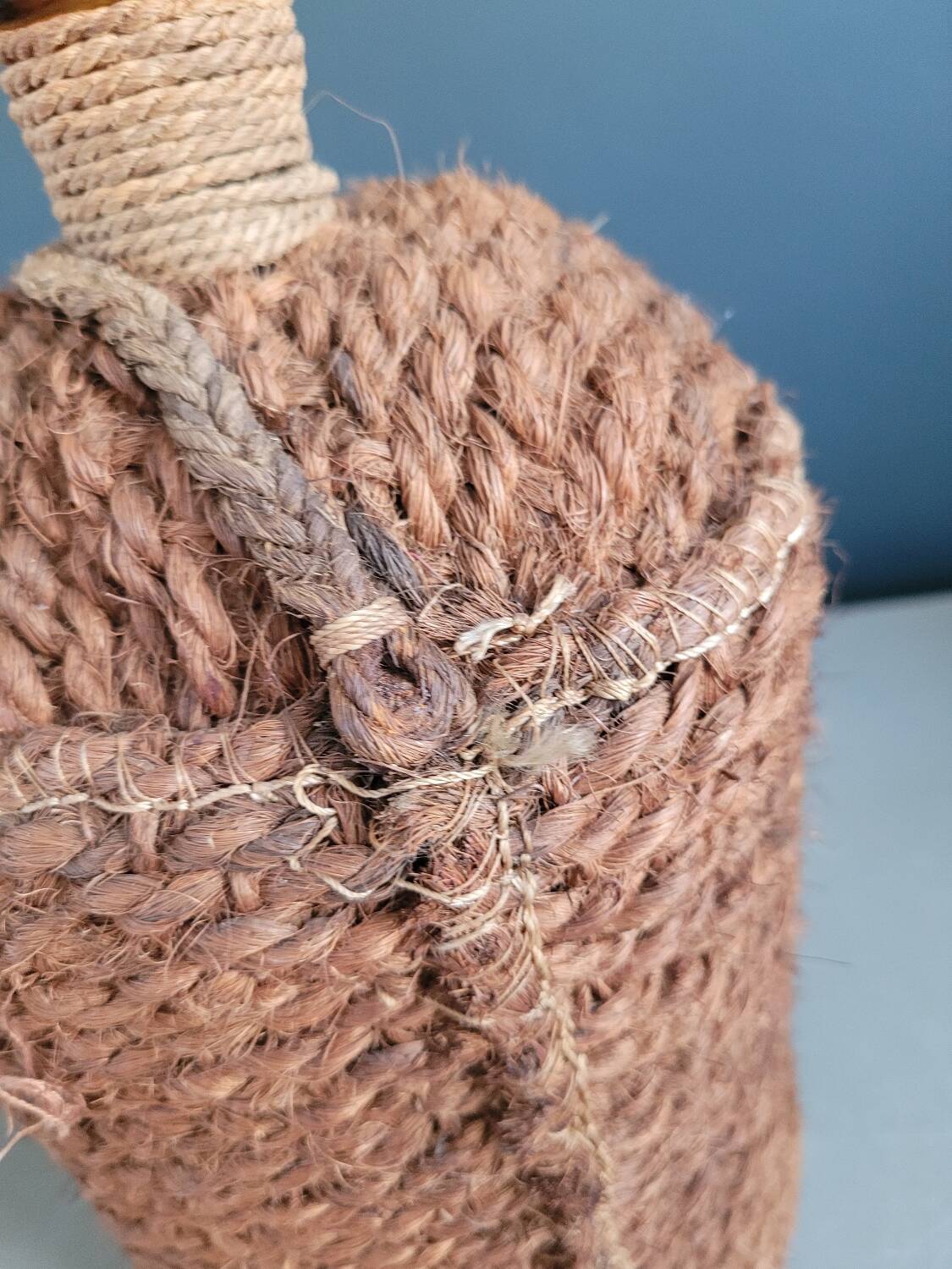 Antique amber glass bottle and hemp carrying bag