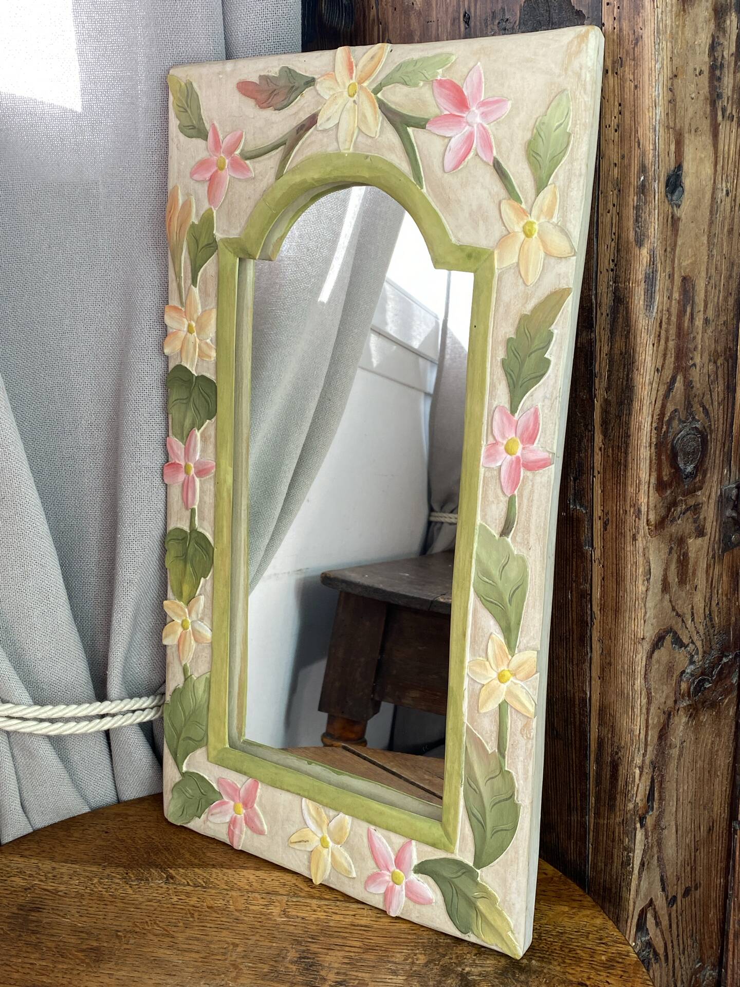 Carved wooden mirror, colourful floral decoration.