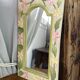 Carved wooden mirror, colourful floral decoration.