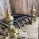 Pair of andirons and grates in cast iron and bronze with gilded grotesques, 17th century