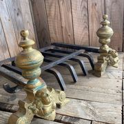 Pair of andirons and grates in cast iron and bronze with gilded grotesques, 17th century