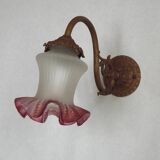 French Art Nouveau wall sconce in bronze with a white and pink glass shade.