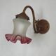 French Art Nouveau wall sconce in bronze with a white and pink glass shade.