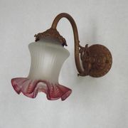 French Art Nouveau wall sconce in bronze with a white and pink glass shade.