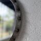 Brutalist round mirror with wrought iron and studs.