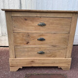 Raw wood chest of drawers with three drawers and shell handles.