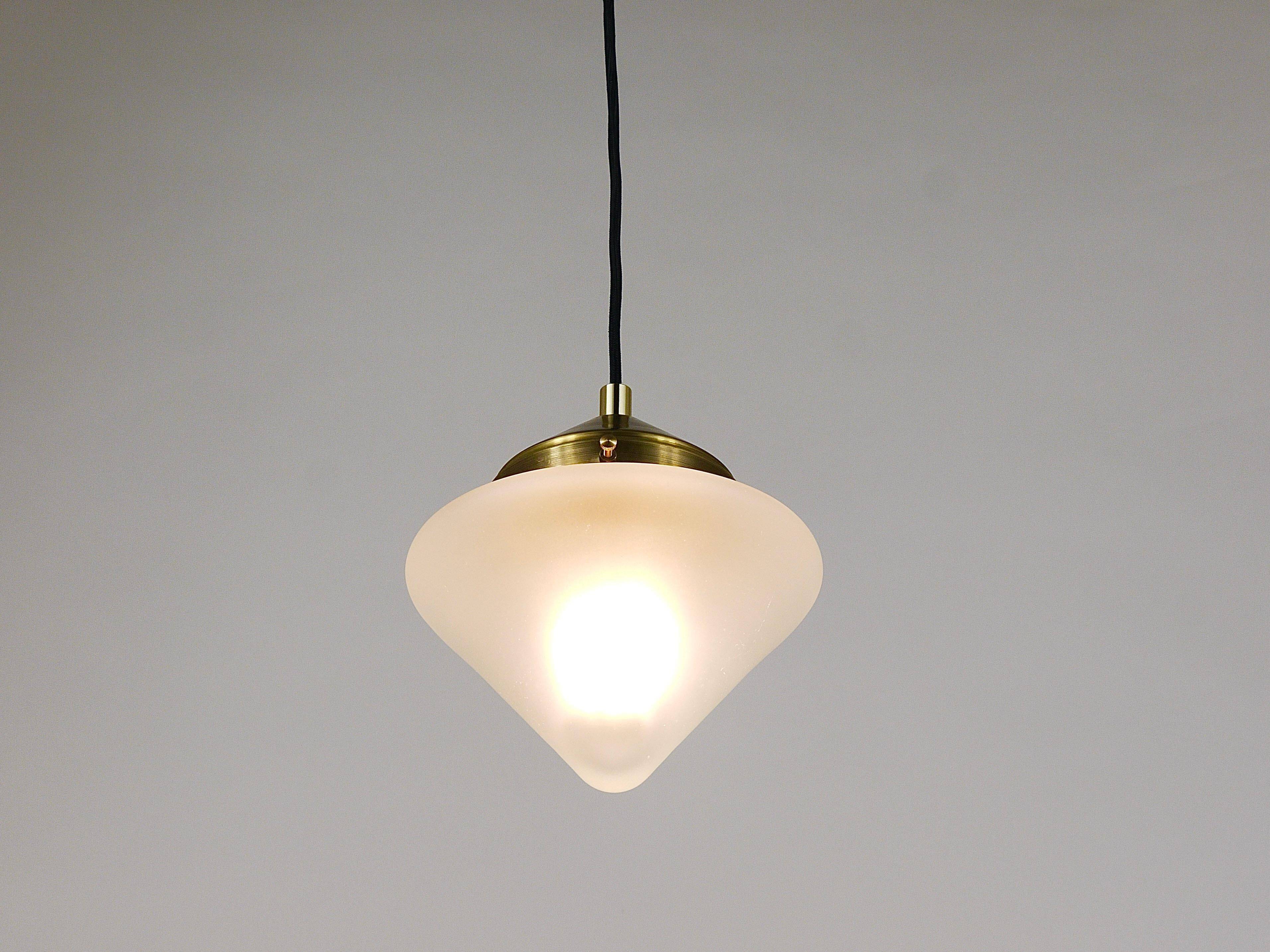 Up to 7 Art Deco brass pendant lights with conical glass shades, Vienna 1930s.