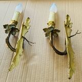 Bronze wall lights in the Louis XV style with curved branches and leaf decorations.