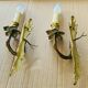 Bronze wall lights in the Louis XV style with curved branches and leaf decorations.