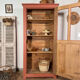 Antique glass-fronted terracotta cupboard