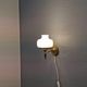 Older wall lamp, in metal, brass and milk-white glass