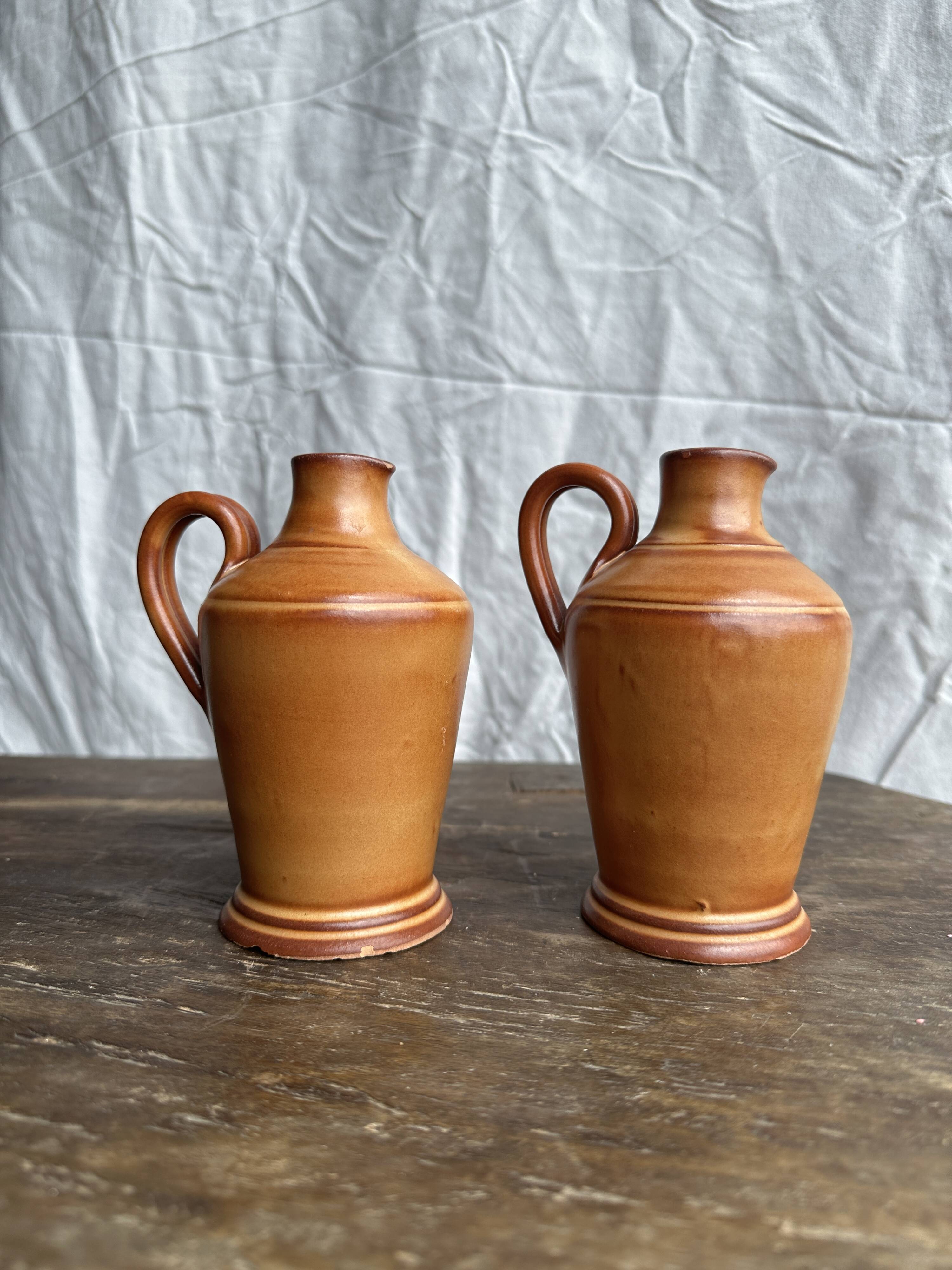 Pair of mini orange stoneware pitchers