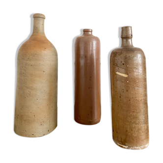 Trio of old sandstone bottles