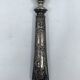 Silver-plated metal leg of lamb handle with engraved thistle flower patterns.