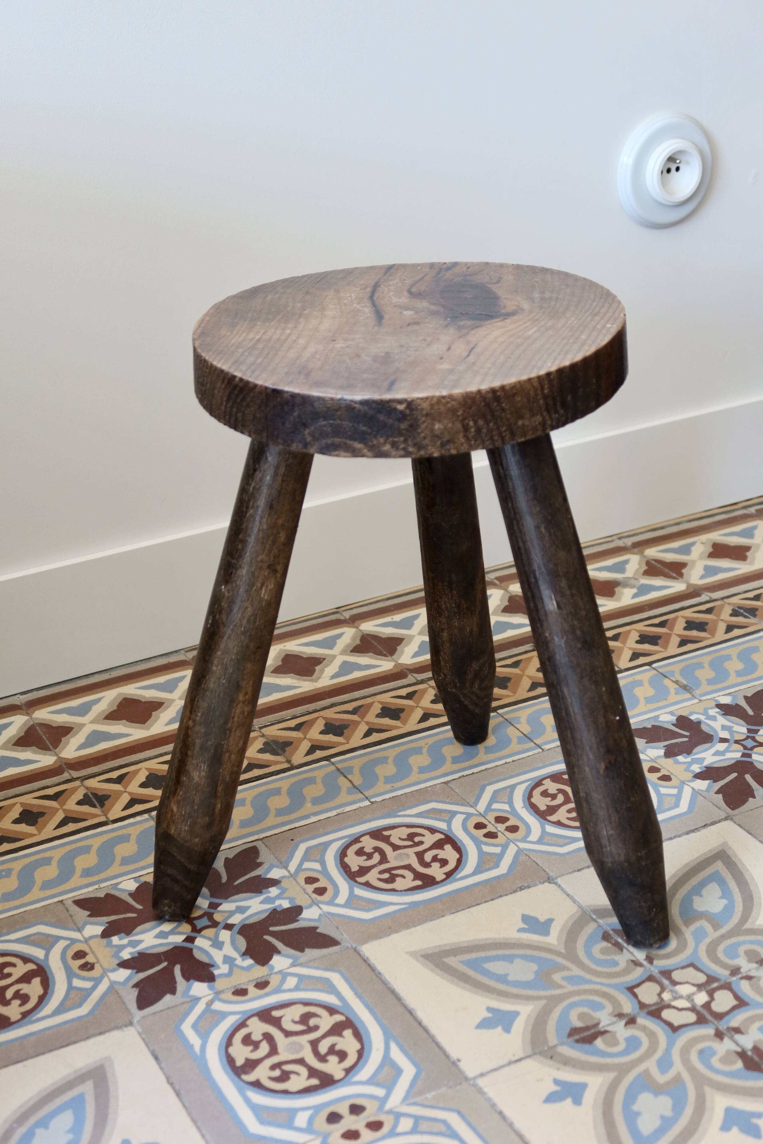 Old dark wood tripod stool
