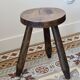 Old dark wood tripod stool