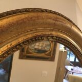 Oval mirror in gilded wood late 19th
