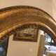 Oval mirror in gilded wood late 19th