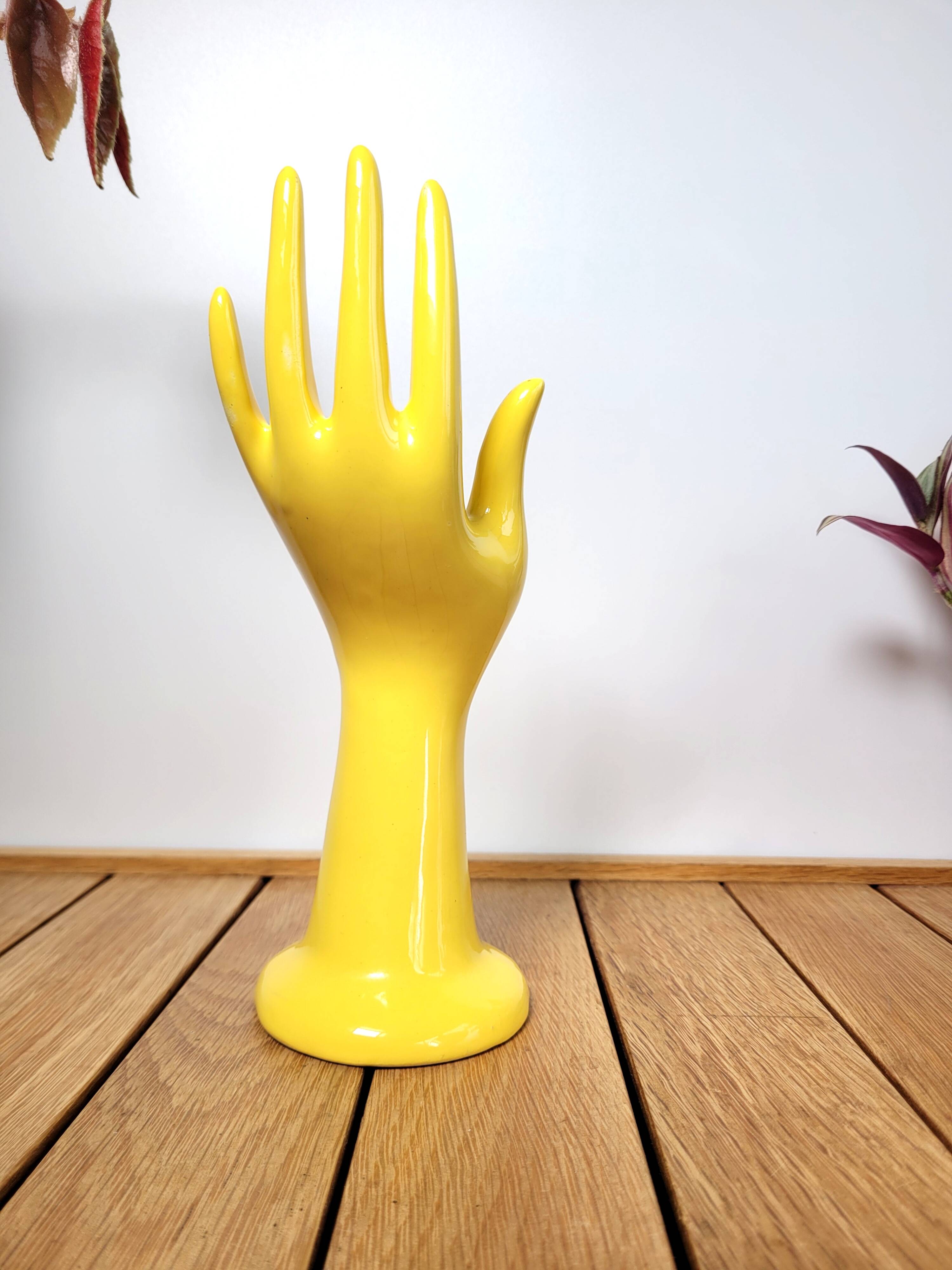 Hand wears ring and yellow soliflore