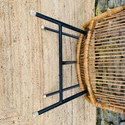 Fauteuil en rotin et piétement en métal noir 1960