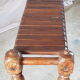 Bench with slats and feet of charpoy beds in teak