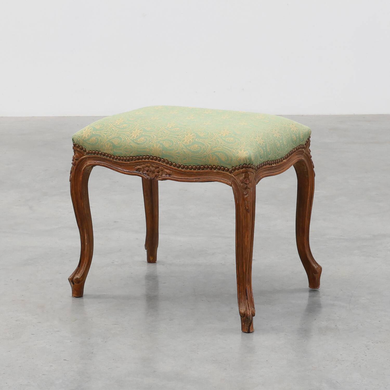 Louis XV stool with carved floral apron and original damask upholstery