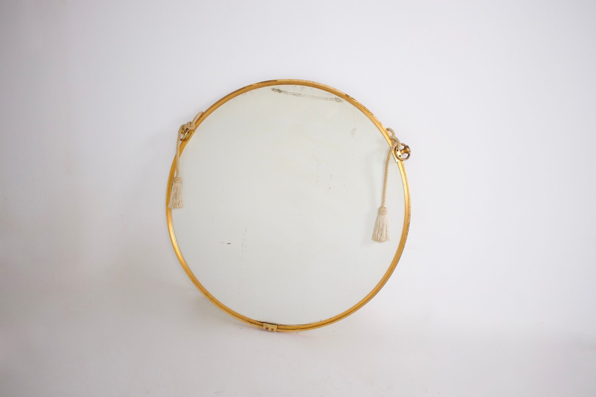 Hanging mirror in gilded brass