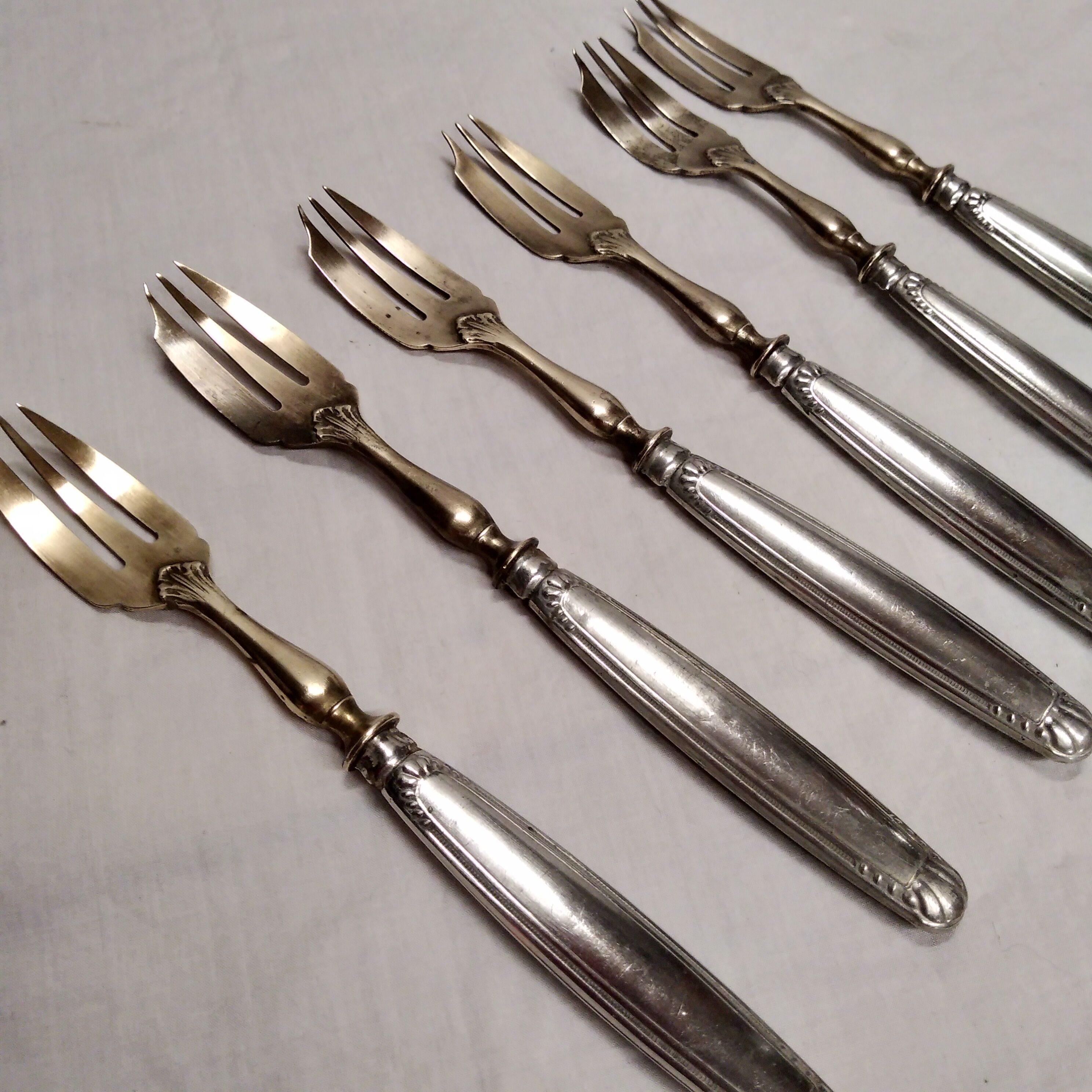 Silver and gold cake fork service