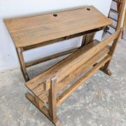 Double school desk and its wooden bench
