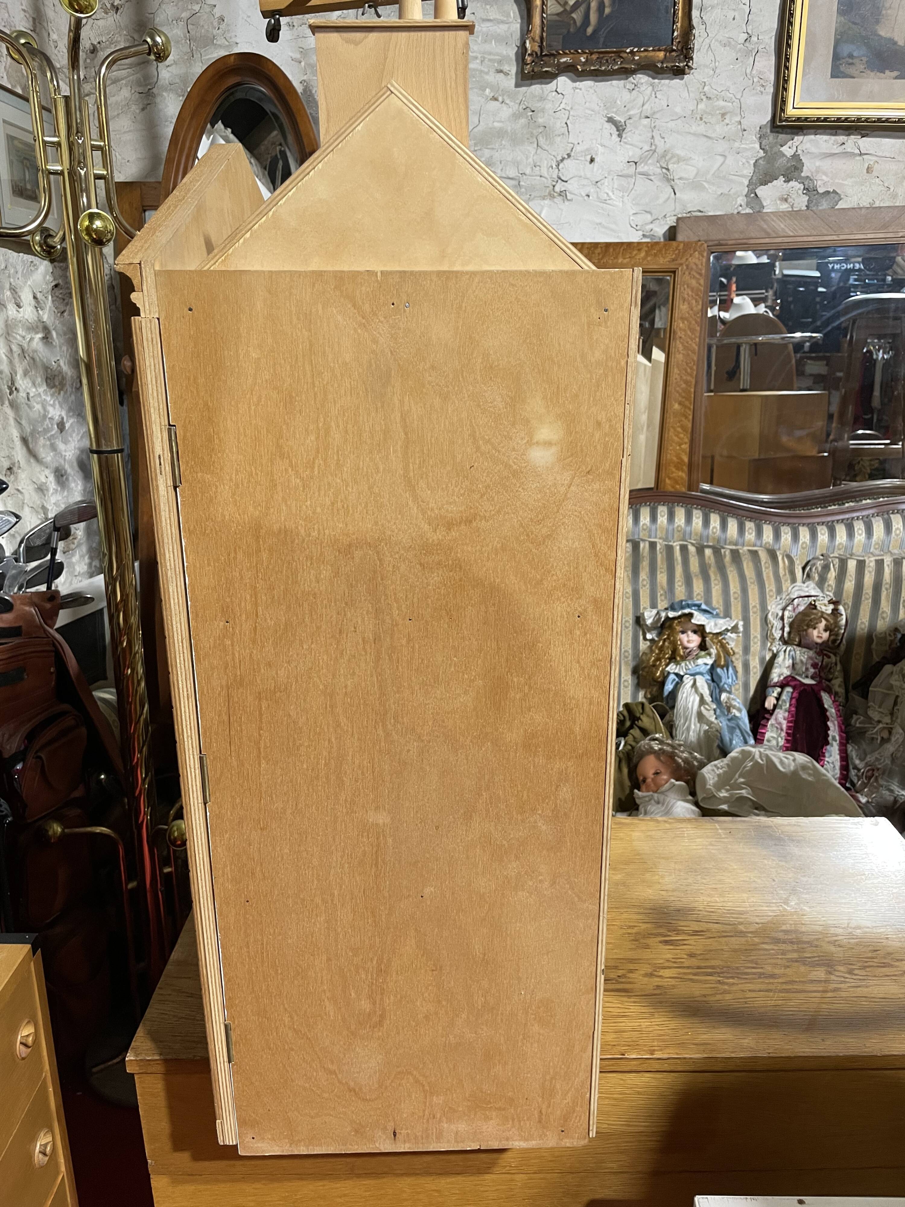 Large wooden dollhouse with miniature furniture