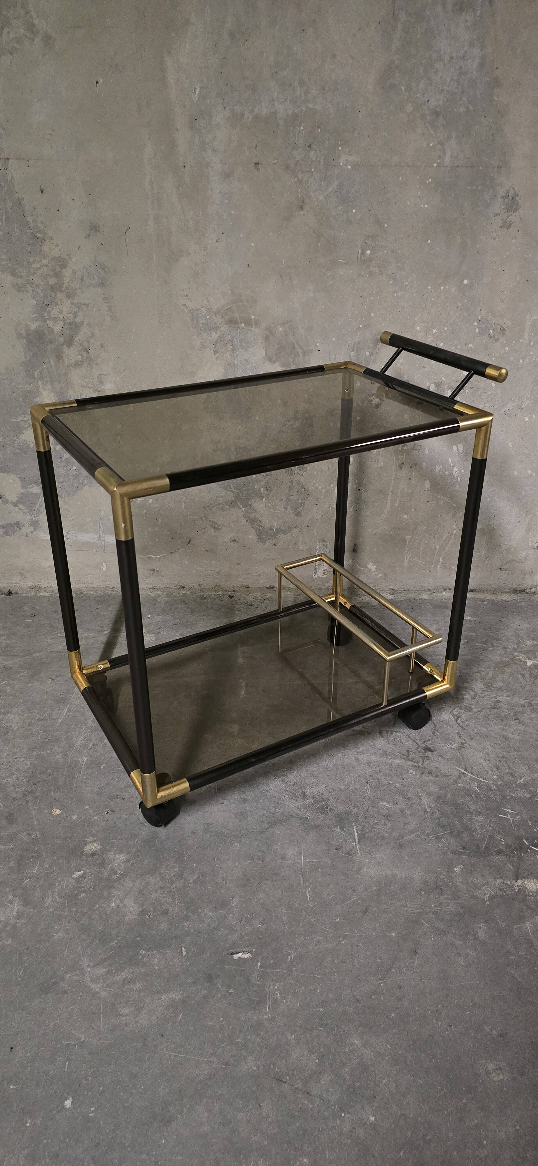 Black metal and brass rolling dessert trolley, smoked glass, 1970s.