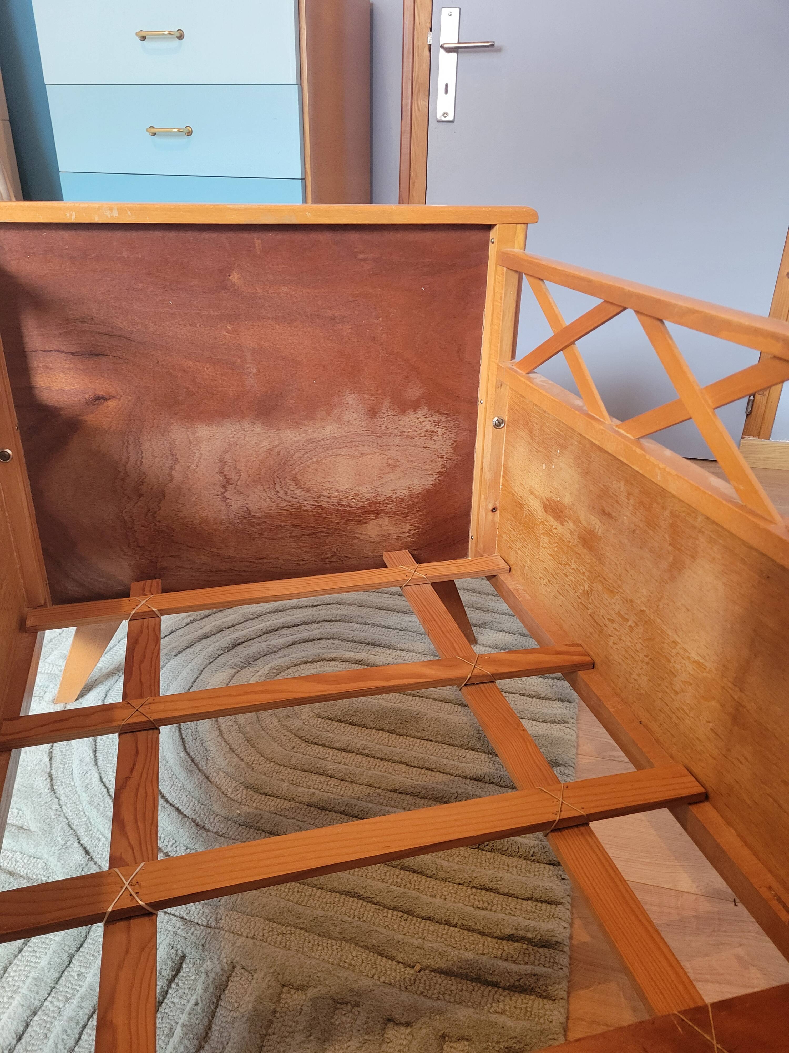 Vintage baby cot with splayed legs.