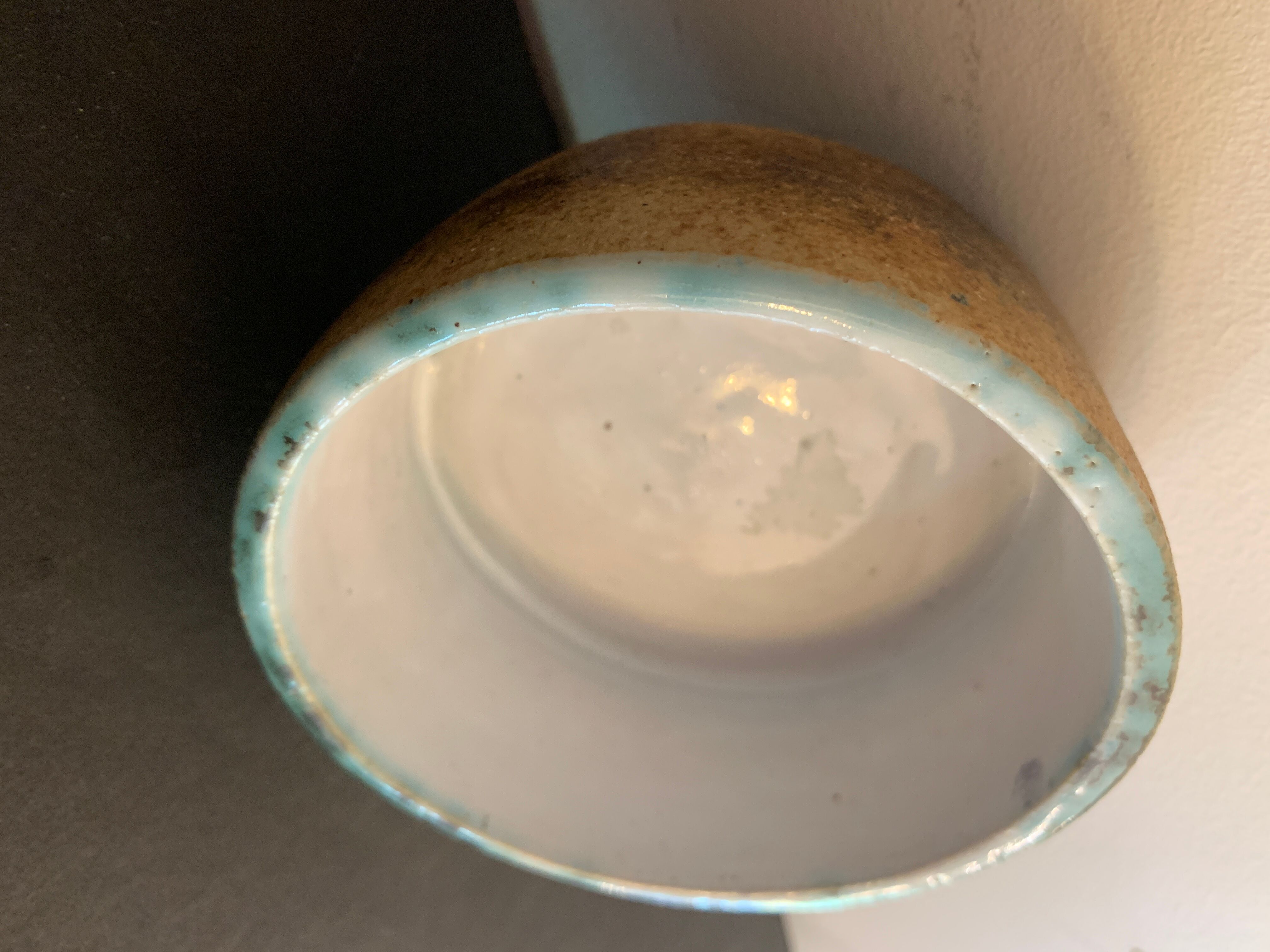 Round ashtray signed in sandstone with glazed interior