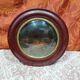 Small round bull's eye wall display case in wood and curved glass