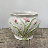 White ceramic pot cache in old flower slip