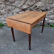 Vintage pine table with drop-leaf extension and turned beech legs, France, 1930s.