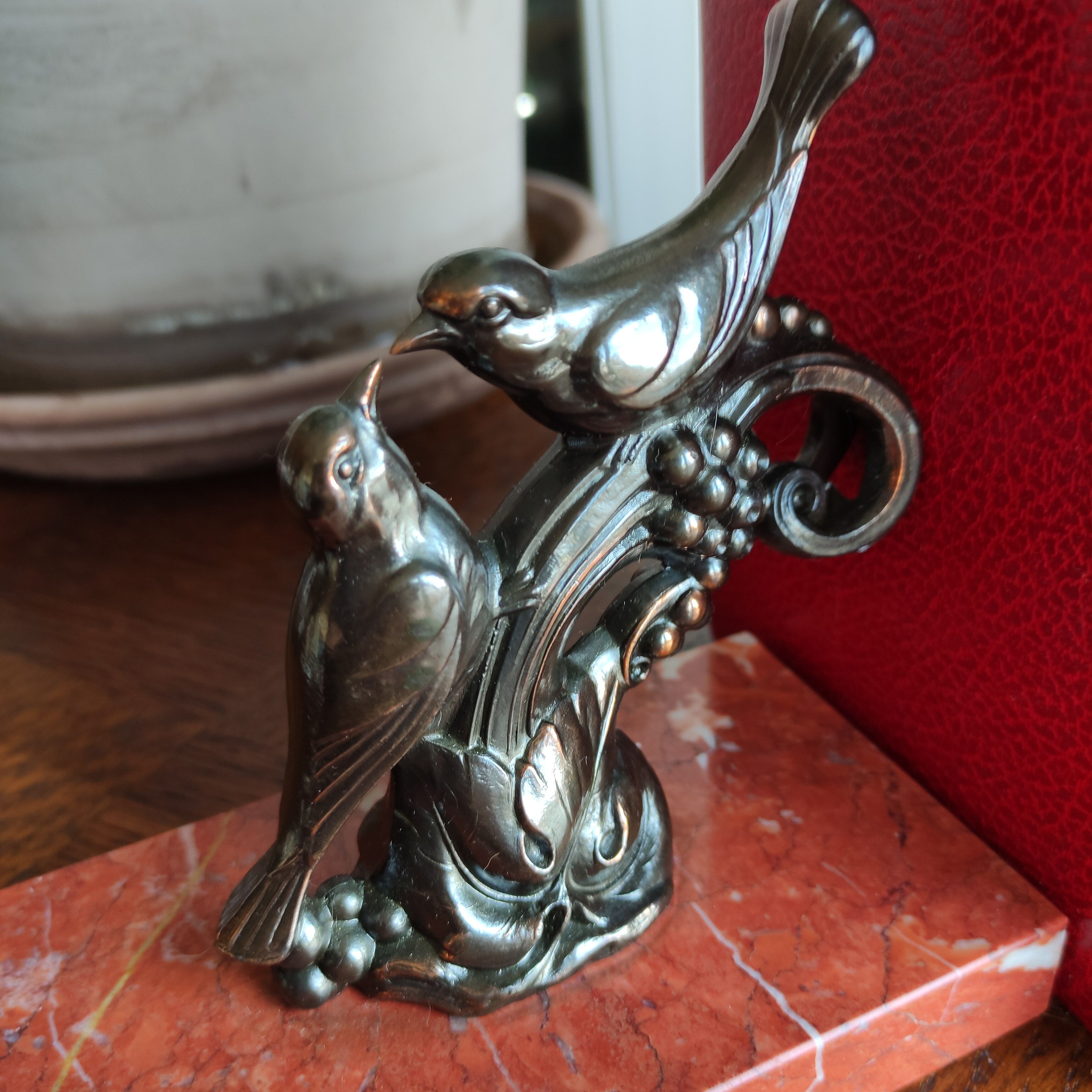 Zinc art bookends in the shape of birds on red marble - warblers