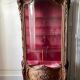 Large wooden display cabinet in Louis XV/rococo style with a strongly curved front.