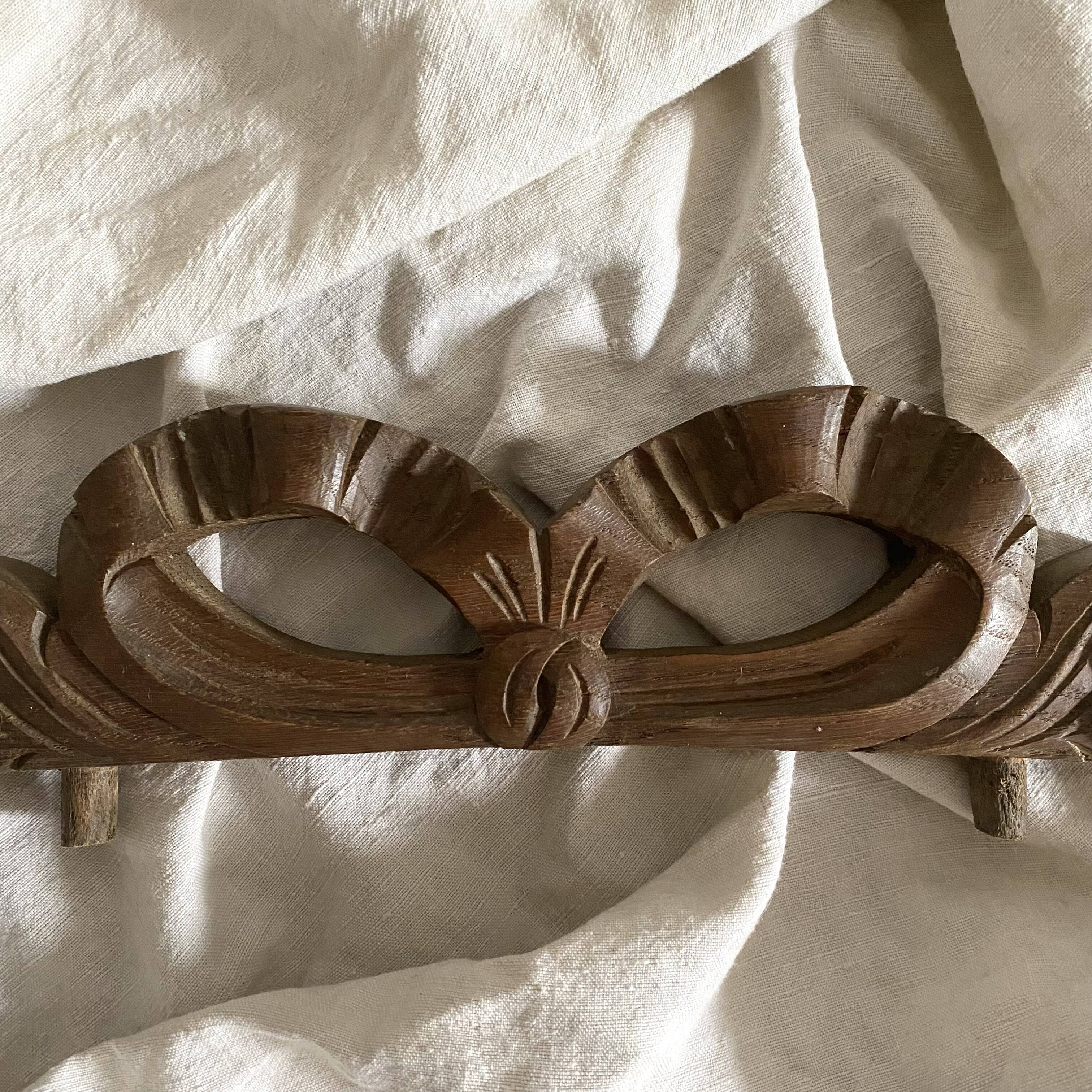Antique carved wooden ribbon pediment